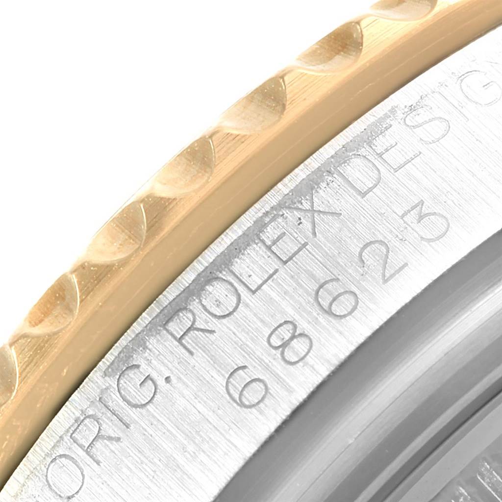 The image shows a detailed close-up of the engraving and bezel of a Rolex Yacht-Master 68623 Steel and Gold (two tone) White Dial 68623 Steel and Gold (two tone) White Dial watch.