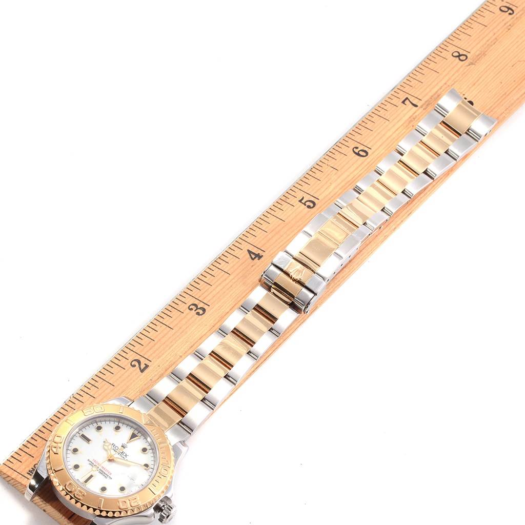 The image shows a top-down view of a Rolex Yacht-Master 68623 Steel and Gold (two tone) White Dial 68623 Steel and Gold (two tone) White Dial watch alongside a ruler, displaying the watch face and band.