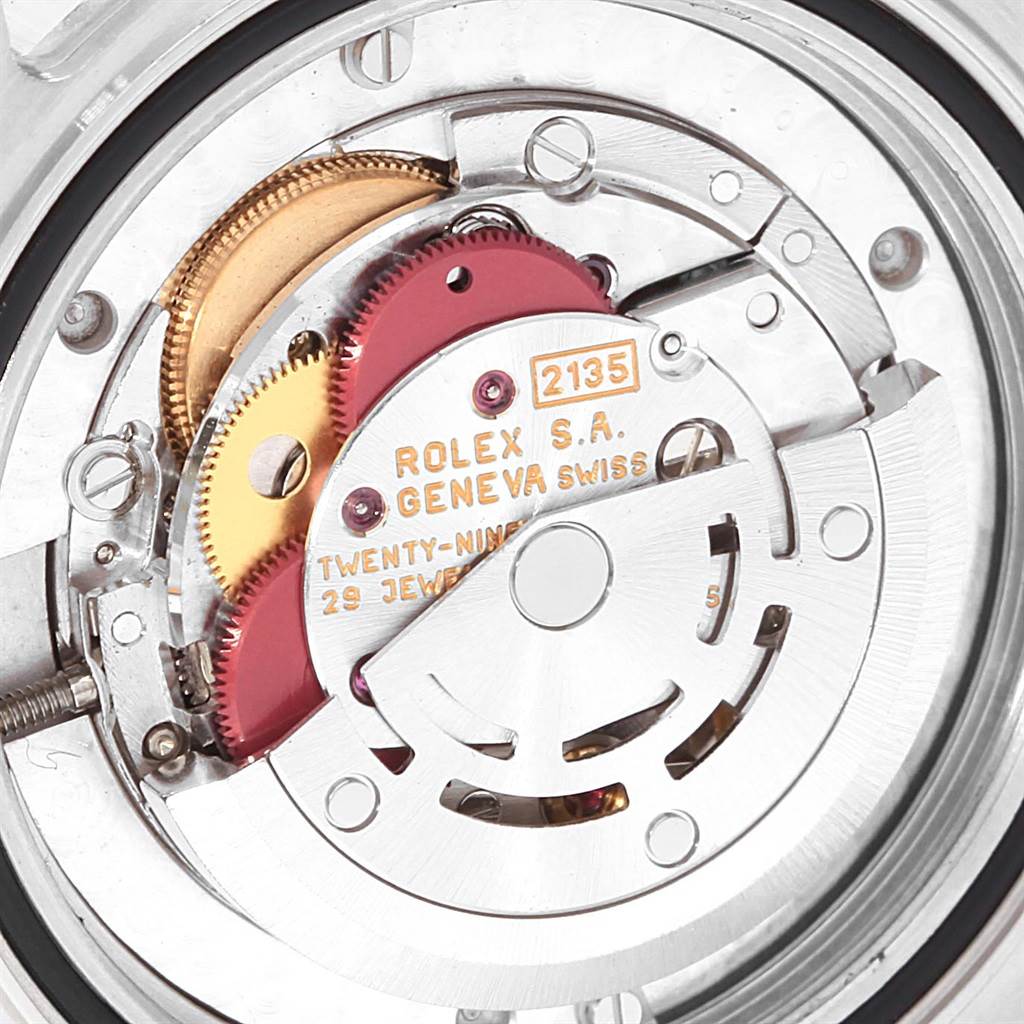This image shows the intricate movement mechanism of a Rolex Yacht-Master 68623 Steel and Gold (two tone) White Dial 68623 Steel and Gold (two tone) White Dial watch from a close-up angle, highlighting the rotor and gears.