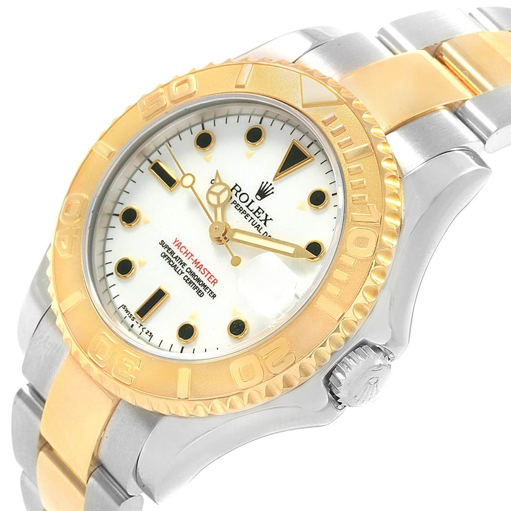 The image shows a close-up of the Rolex Yacht-Master 68623 Steel and Gold (two tone) White Dial 68623 Steel and Gold (two tone) White Dial watch's dial, bezel, crown, and part of the bracelet at an angled view.