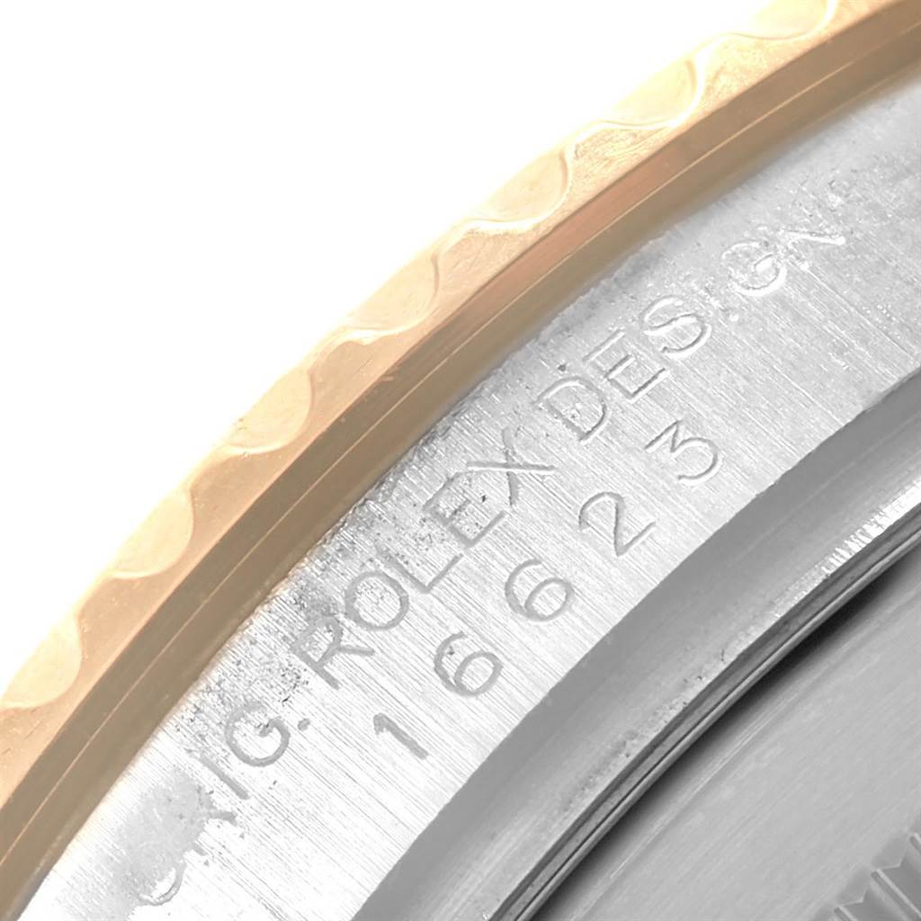 This close-up angle shows the etched text "ORIG. ROLEX DESIGN" on the side of the bezel of a Rolex Yacht-Master 16623 Men's Stainless Steel White Dial 16623 Men's Stainless Steel White Dial watch.