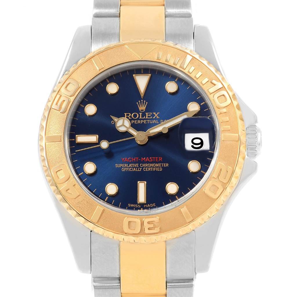 The image shows a front view of a Rolex Yacht-Master 168623 Men's Steel and Gold (two tone) Blue Dial 168623 Men's Steel and Gold (two tone) Blue Dial watch featuring a gold bezel, blue dial, and a two-tone metal bracelet.