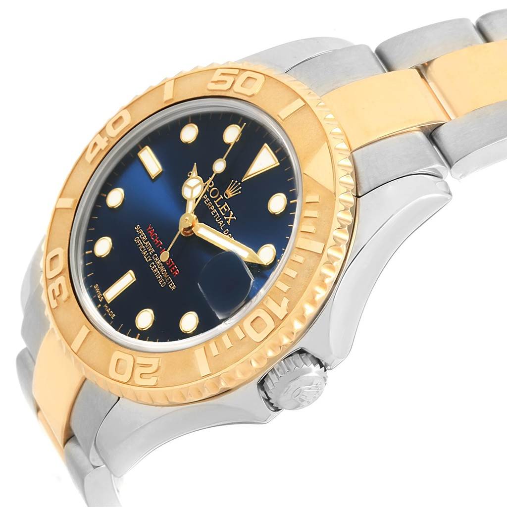 This image shows a side angle of a Rolex Yacht-Master 168623 Men's Steel and Gold (two tone) Blue Dial 168623 Men's Steel and Gold (two tone) Blue Dial watch, highlighting its blue dial, gold bezel, and two-tone bracelet.