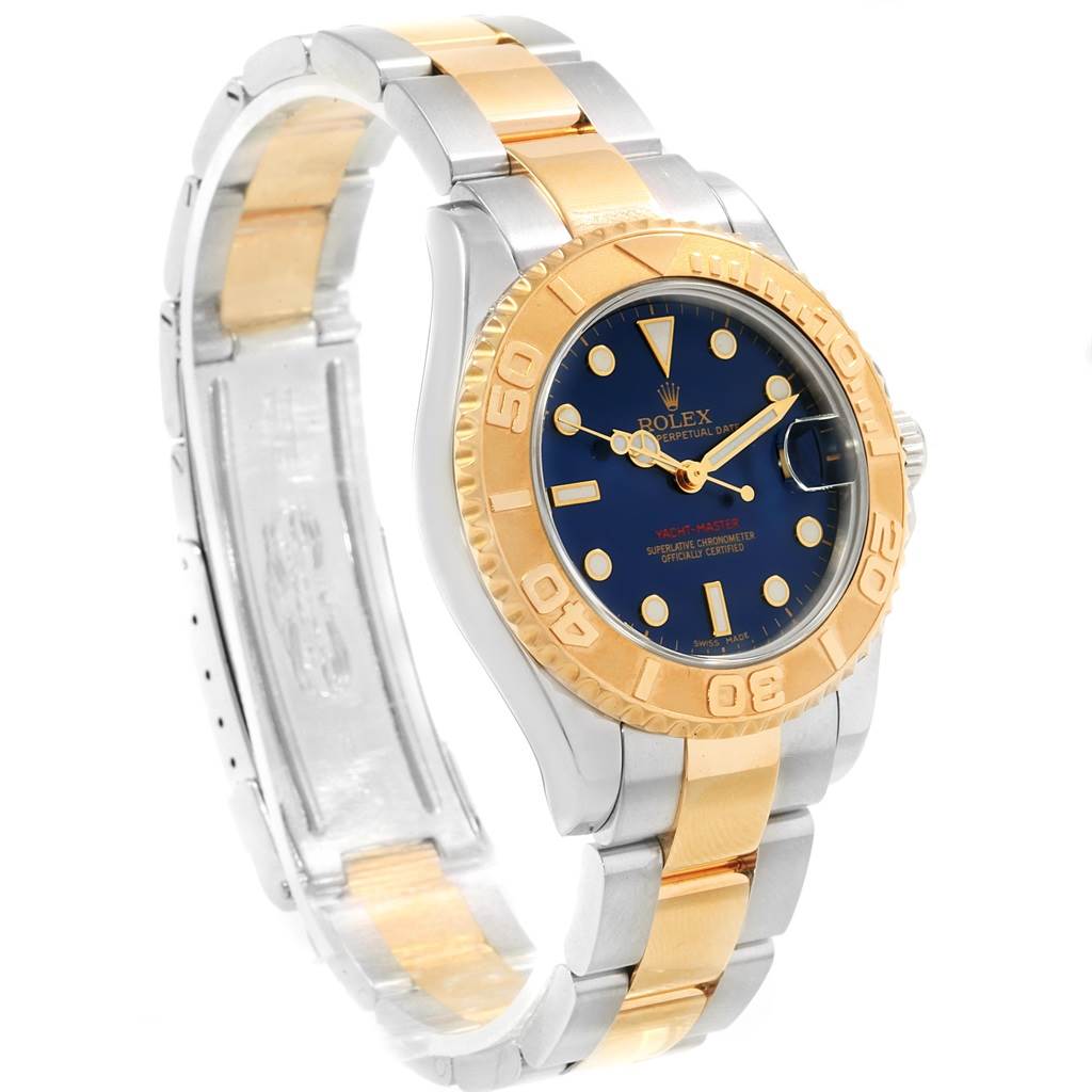 The Rolex Yacht-Master 168623 Men's Steel and Gold (two tone) Blue Dial 168623 Men's Steel and Gold (two tone) Blue Dial watch is shown at a three-quarter angle, displaying the face, bezel, and two-tone bracelet.