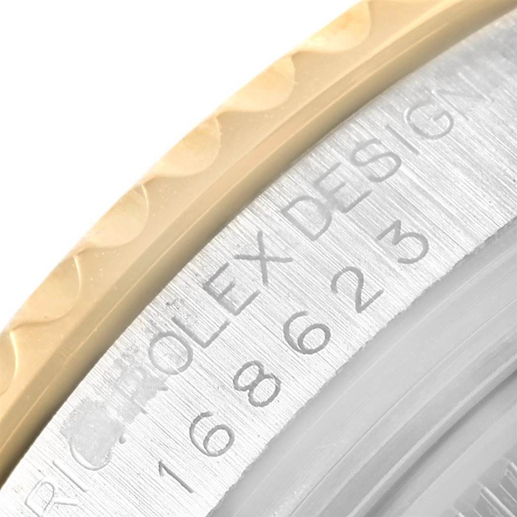 This image shows a close-up angle of the bezel and part of the case back of a Rolex Yacht-Master 168623 Men's Steel and Gold (two tone) Blue Dial 168623 Men's Steel and Gold (two tone) Blue Dial watch, highlighting the engraved details.