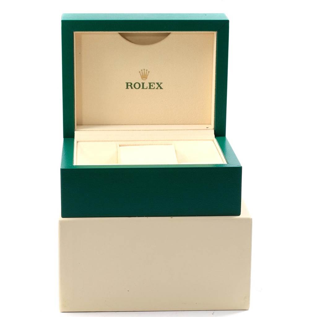 The image shows an open green and beige Rolex watch box, likely for the Yacht-Master model.