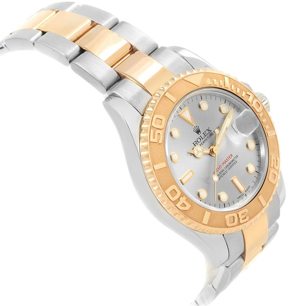 The image shows an angled side view of a Rolex Yacht-Master 168623 Men's Steel and Gold (two tone) Grey Dial 168623 Men's Steel and Gold (two tone) Grey Dial watch, highlighting its gold bezel, bracelet, and dial.