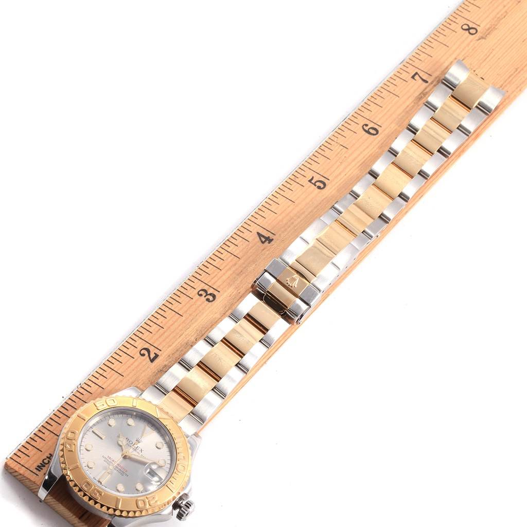 The image shows a Rolex Yacht-Master 168623 Men's Steel and Gold (two tone) Grey Dial 168623 Men's Steel and Gold (two tone) Grey Dial watch laid flat against a ruler, displaying the dial, bezel, and bracelet.
