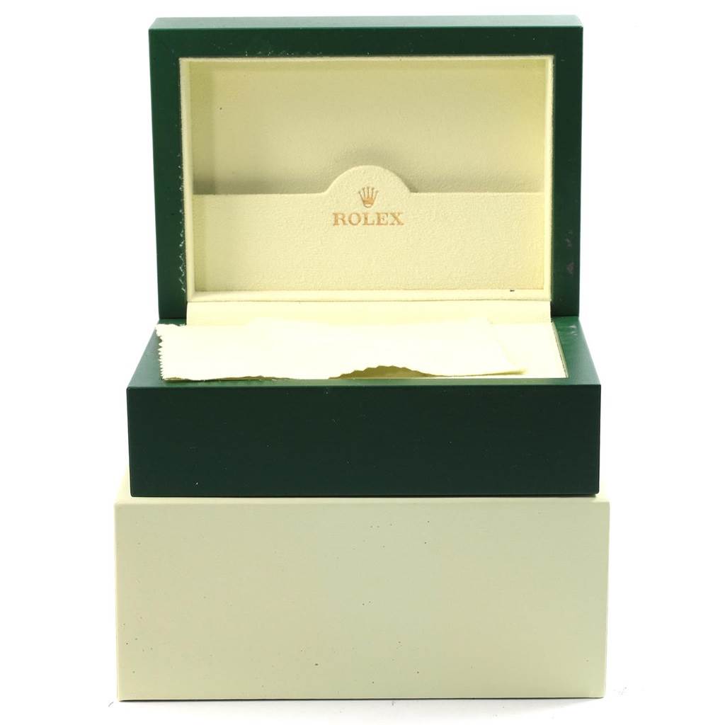 The image shows an open box of a Yacht-Master Rolex watch, featuring a green outer case and beige interior.