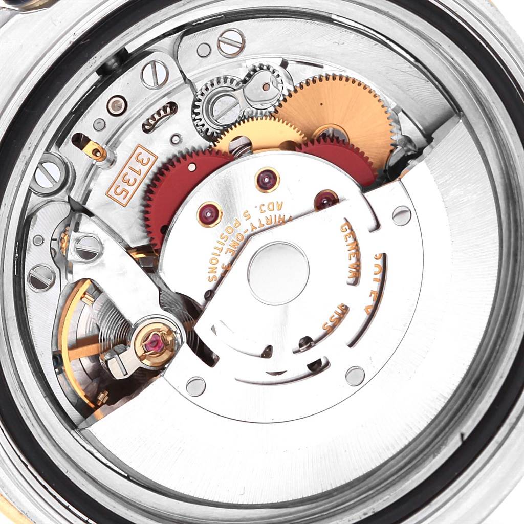 The image shows the internal mechanism of a Rolex Yacht-Master 16623 Men's Stainless Steel White Dial 16623 Men's Stainless Steel White Dial watch, highlighting gears and movement parts.