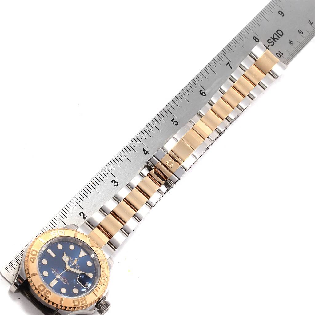 The image shows a top-down view of the Rolex Yacht-Master 16623 Men's Stainless Steel Blue Dial 16623 Men's Stainless Steel Blue Dial watch, displaying the face, bezel, bracelet, and clasp, aligned with a ruler.