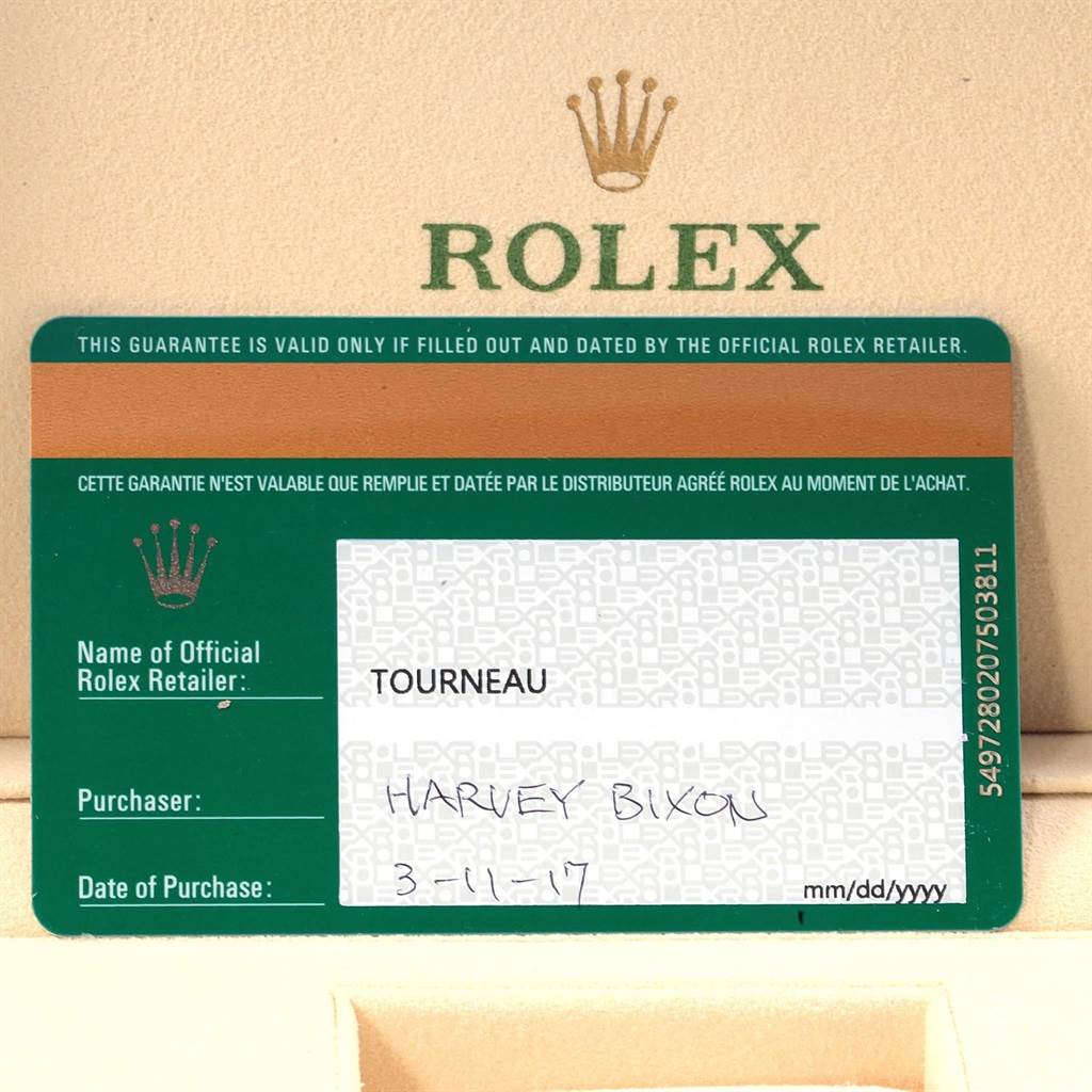 This image shows the guarantee card of a Rolex Yacht-Master 16623 Men's Stainless Steel Blue Dial 16623 Men's Stainless Steel Blue Dial watch placed on a beige leather surface.