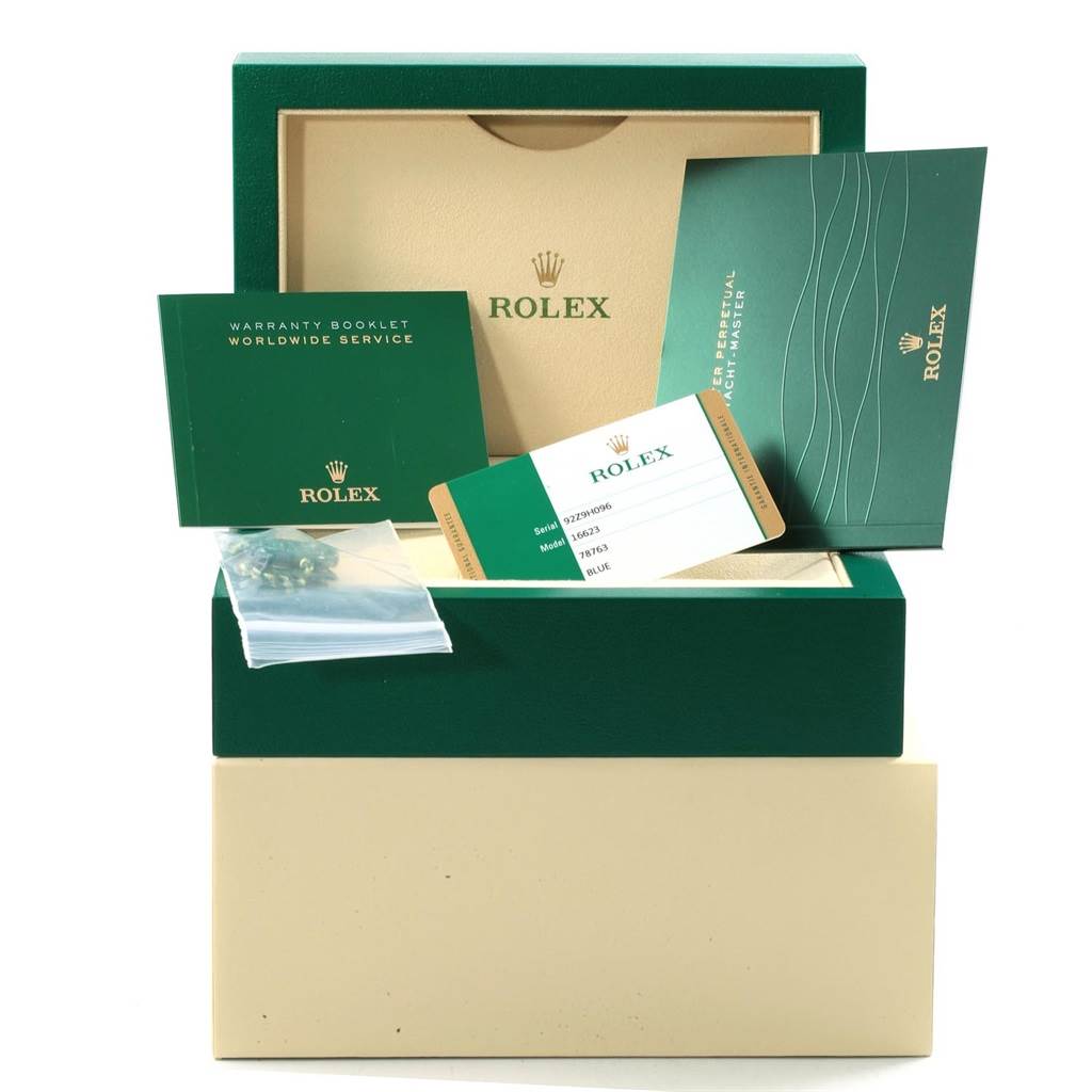 This image shows the Rolex Yacht-Master 16623 Men's Stainless Steel Blue Dial 16623 Men's Stainless Steel Blue Dial accessories including the box, warranty booklet, card, and manuals.