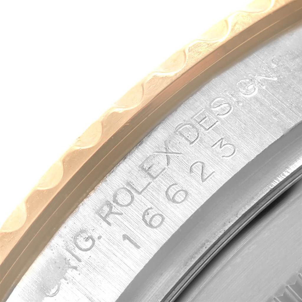 This close-up image of a Rolex Yacht-Master 16623 Men's Stainless Steel White Dial 16623 Men's Stainless Steel White Dial watch shows the bezel and part of the engraved case.