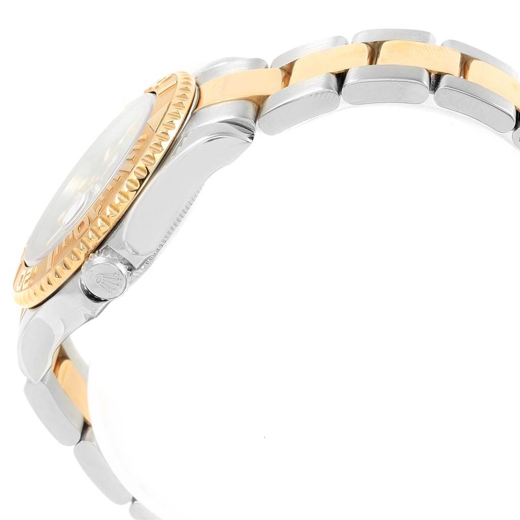 The image shows a side view of the Rolex Yacht-Master 168623 Men's Steel and Gold (two tone) Blue Dial 168623 Men's Steel and Gold (two tone) Blue Dial with focus on the gold bezel, crown, and the two-tone bracelet.