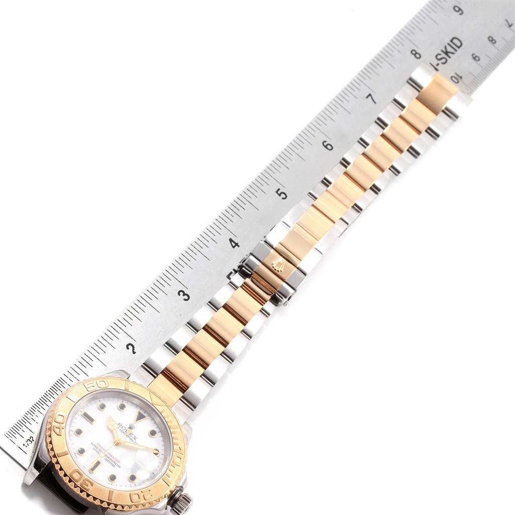 This image shows a Rolex Yacht-Master 16623 Men's Stainless Steel White Dial 16623 Men's Stainless Steel White Dial watch laid flat with a measuring ruler, highlighting the bracelet and part of the dial.