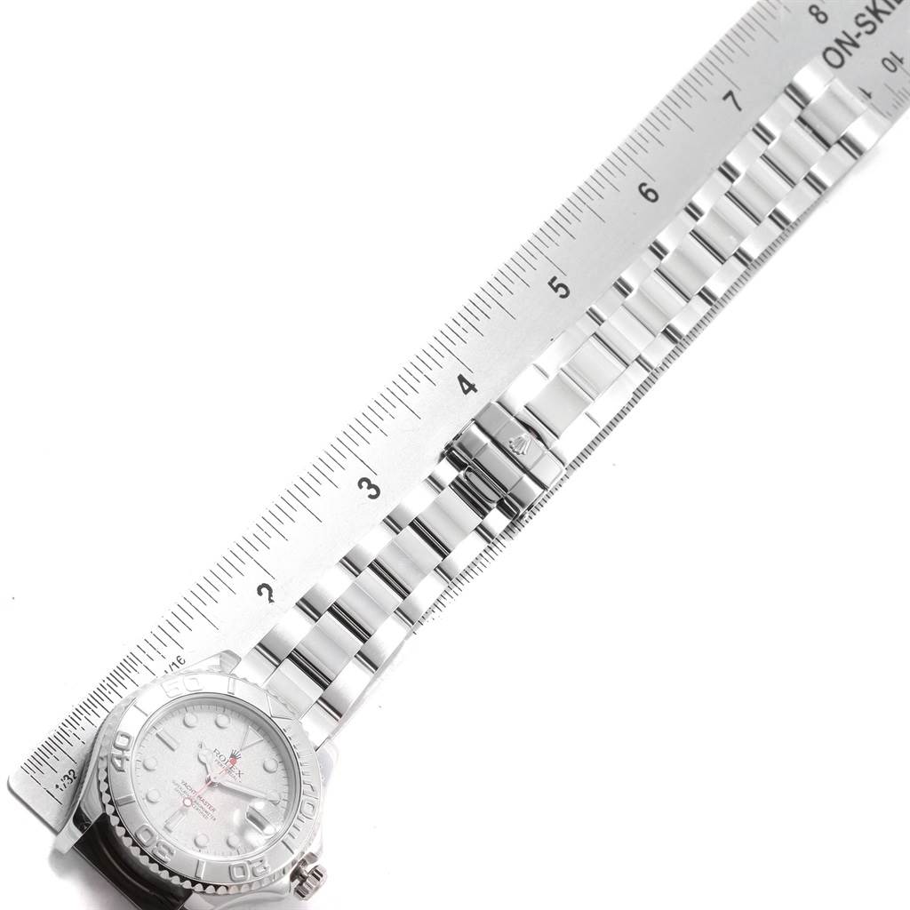 The image shows a top-down view of a Rolex Yacht-Master 168622 Men's Stainless Steel Silver Dial 168622 Men's Stainless Steel Silver Dial watch with its bracelet laid next to a ruler for measurement.