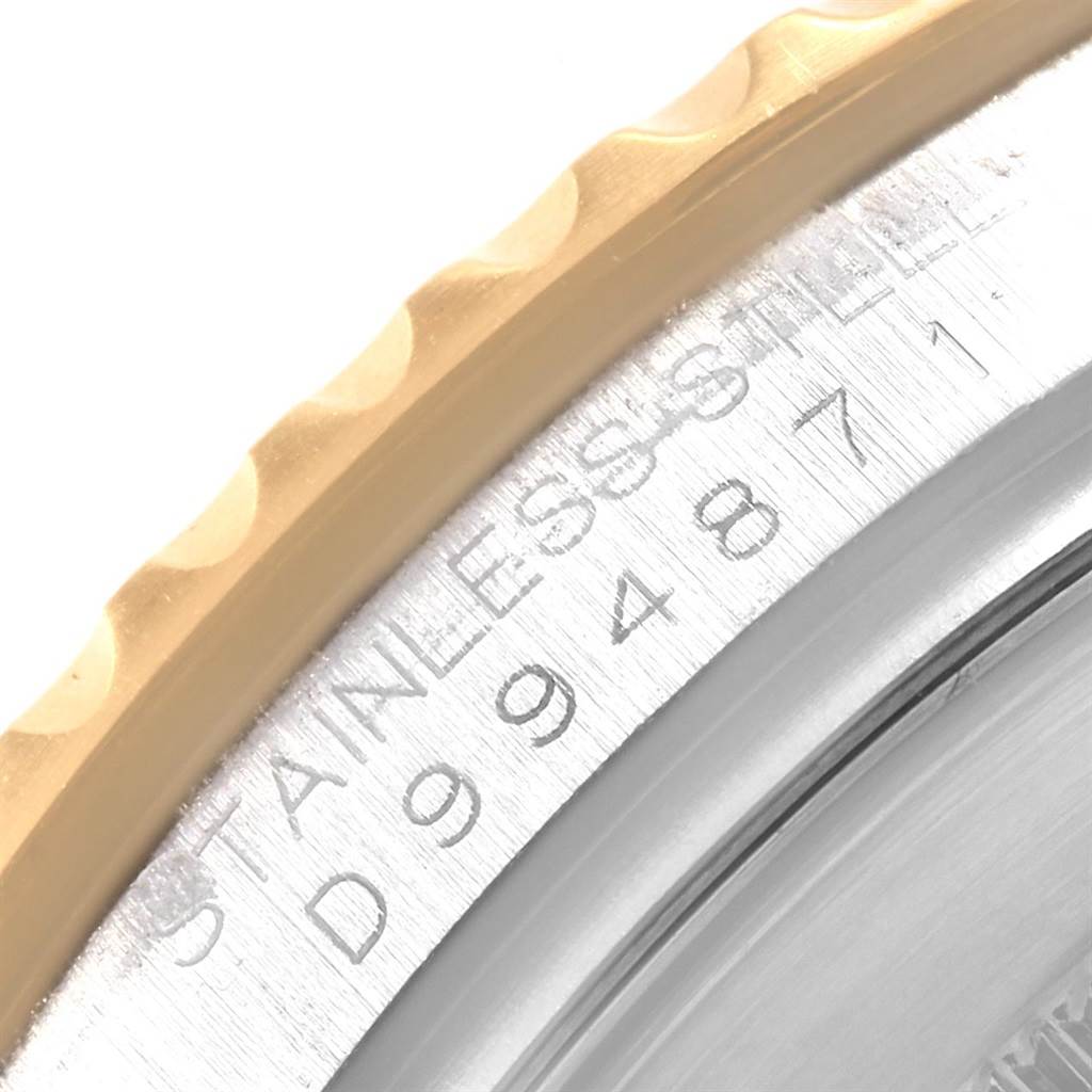 The image shows a close-up of the bezel and case-back of a Rolex Yacht-Master 16623 Men
s Stainless Steel White Dial 16623 Men
s Stainless Steel White Dial watch, highlighting the serial number and "STAINLESS STEEL" engraving.