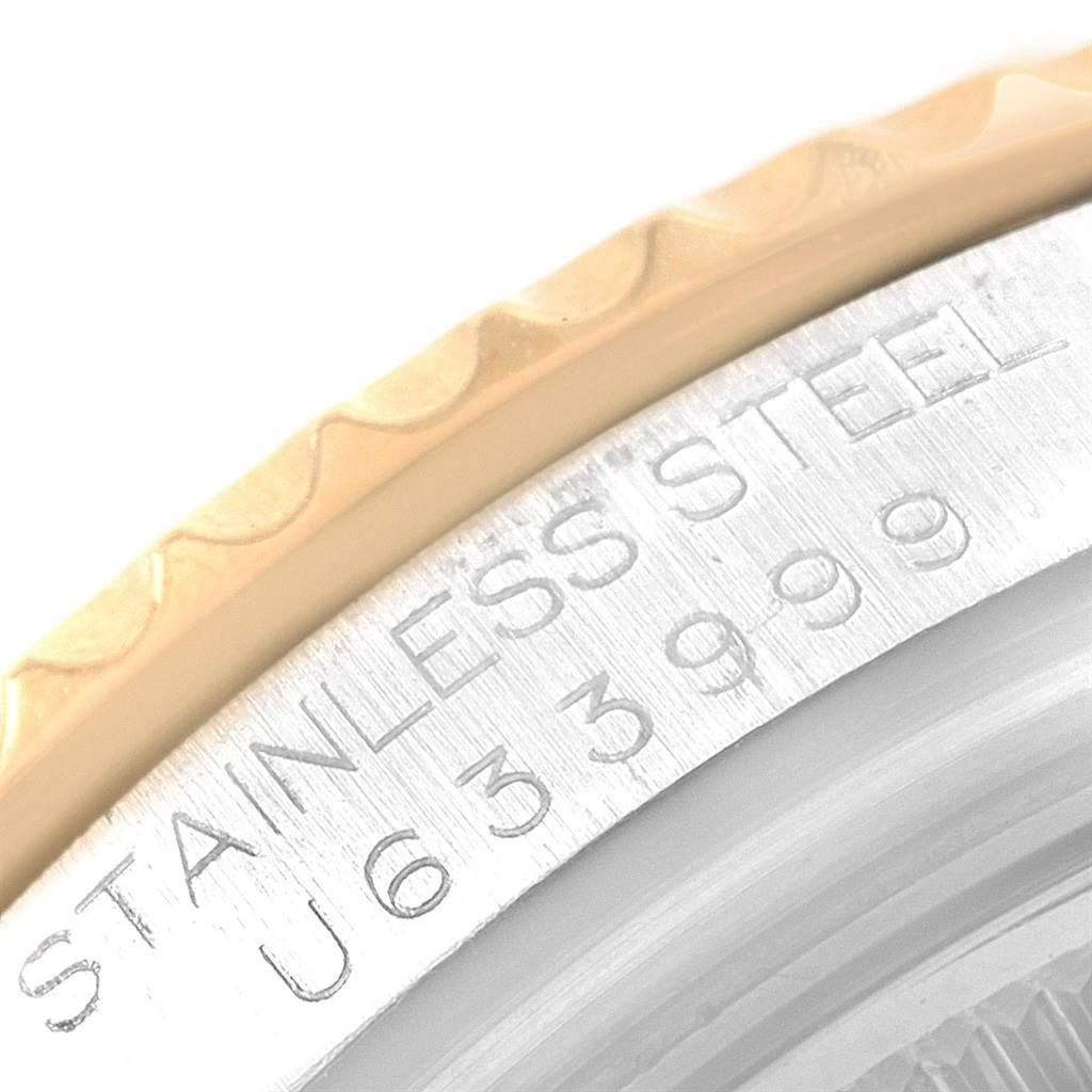 The image shows a close-up of the stainless steel bezel and engraved serial number of a Rolex Yacht-Master 68623 Men's Steel and Gold (two tone) White Dial 68623 Men's Steel and Gold (two tone) White Dial watch.