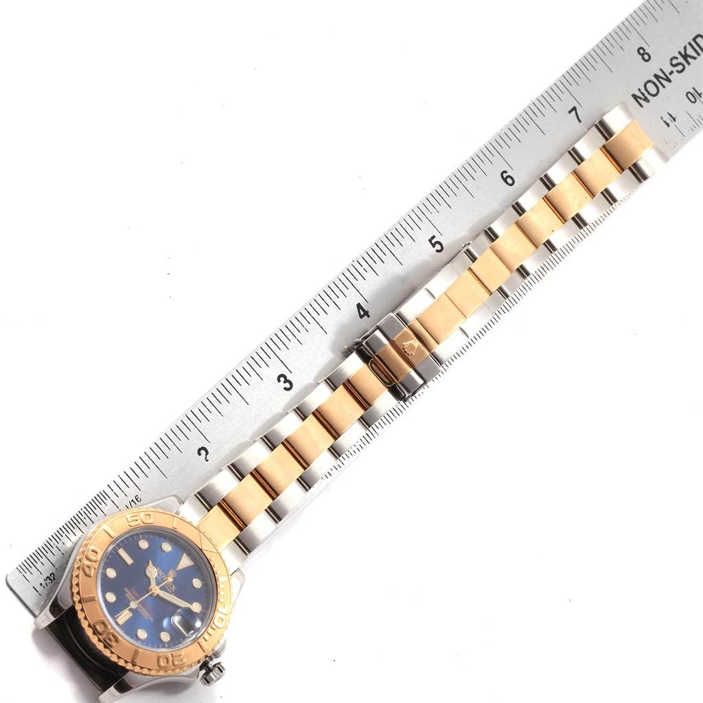 This image shows the Rolex Yacht-Master 168623 Men's Steel and Gold (two tone) Blue Dial 168623 Men's Steel and Gold (two tone) Blue Dial watch face, bezel, and full bracelet, measured against a ruler.
