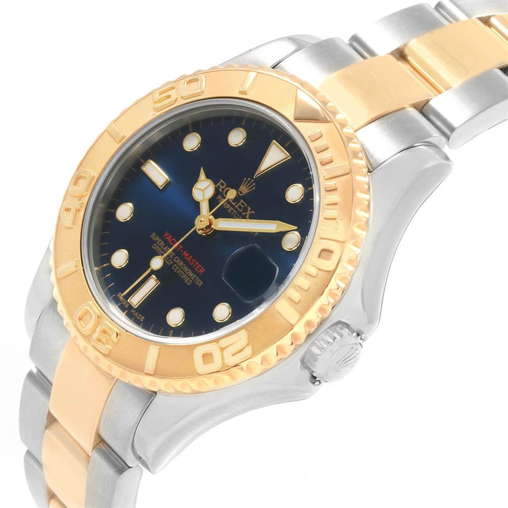 This Rolex Yacht-Master 168623 Men's Steel and Gold (two tone) Blue Dial 168623 Men's Steel and Gold (two tone) Blue Dial watch is shown at an angle highlighting the bezel, dial, case, and bracelet.