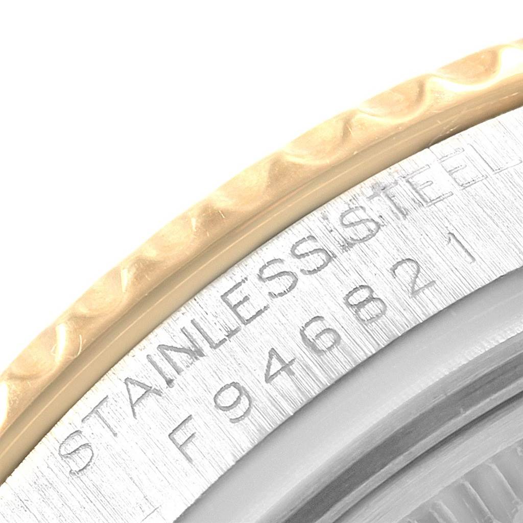 The image shows a close-up of the Yacht-Master Rolex watch's case side, with "STAINLESS STEEL" and a part of the serial number visible.