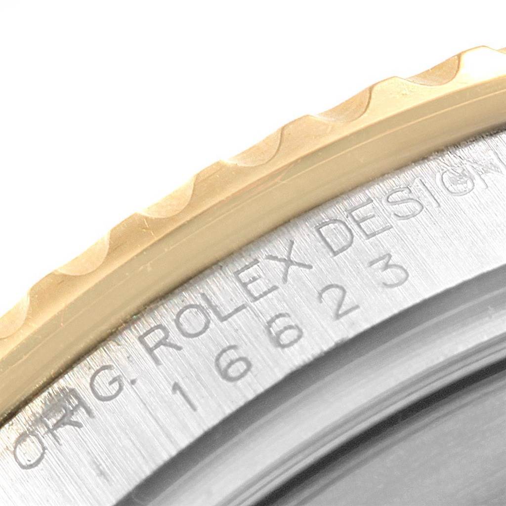 The image shows a close-up of the bezel and case side of a Rolex Yacht-Master 16623 Men
s Stainless Steel White Dial 16623 Men
s Stainless Steel White Dial, highlighting engravings.