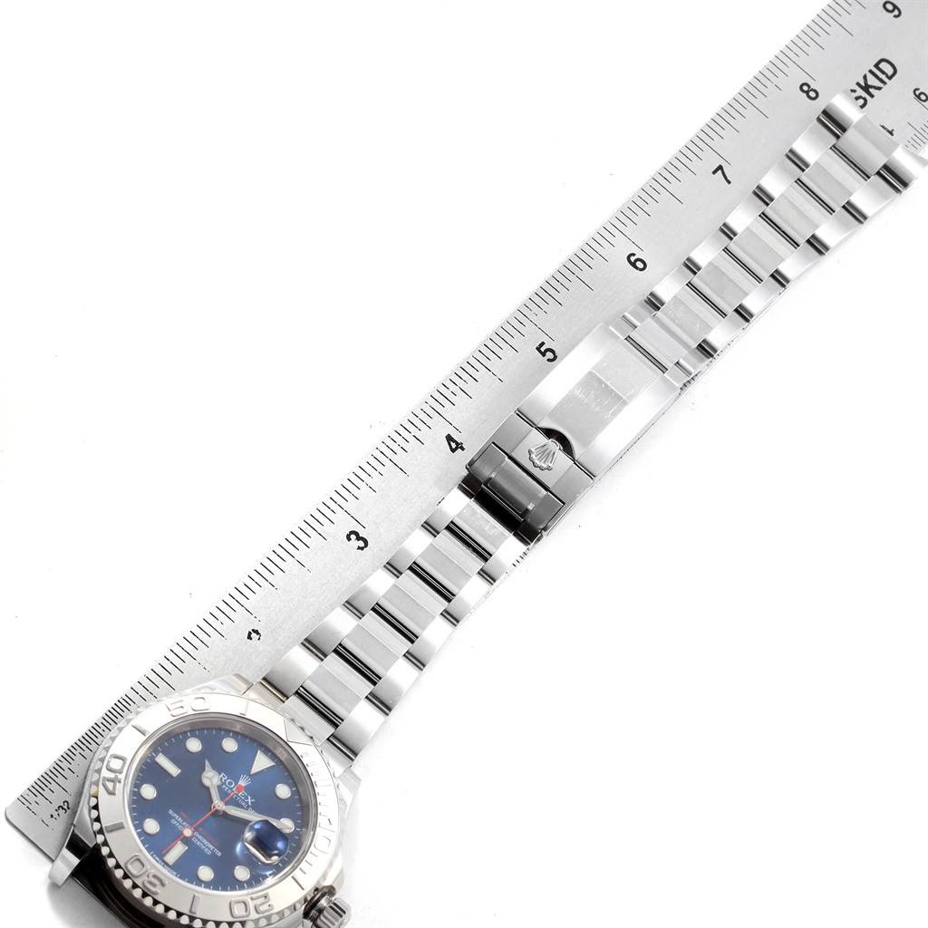 The image shows a side view of the Rolex Yacht-Master 116622 Men's Stainless Steel Blue Dial 116622 Men's Stainless Steel Blue Dial watch with its bracelet and clasp alongside a ruler.