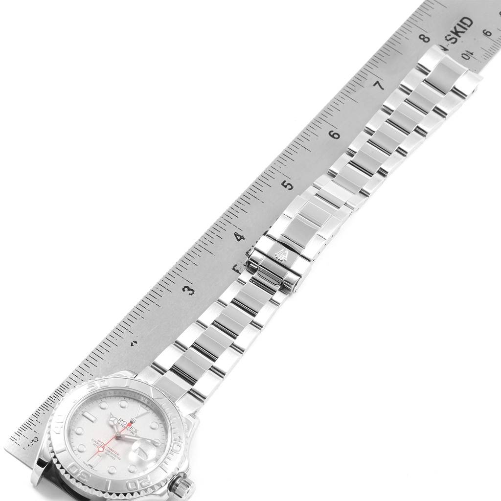 The image shows a side angle of a Rolex Yacht-Master 16622 Men's Stainless Steel Silver Dial 16622 Men's Stainless Steel Silver Dial watch and part of its band being measured with a ruler.