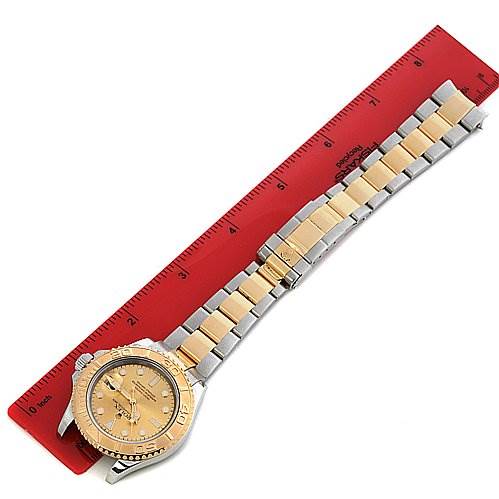 The image shows the top view of a Cartier Tank Francaise 16623 Women's Steel and Gold (two tone) Champagne Dial 16623 Women's Steel and Gold (two tone) Champagne Dial watch with a two-tone metal band, next to a red ruler for scale.