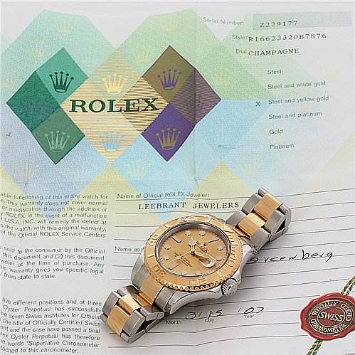 This image shows a Rolex watch with its certificate, partially displaying the dial, bracelet, and warranty information.