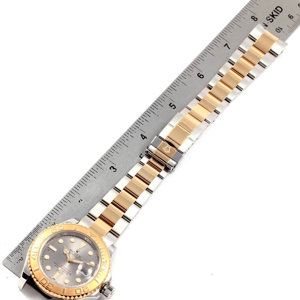 The Rolex Yacht-Master 16623 Men's Stainless Steel Grey Dial 16623 Men's Stainless Steel Grey Dial watch is displayed face-up with its bracelet fully extended alongside a ruler.