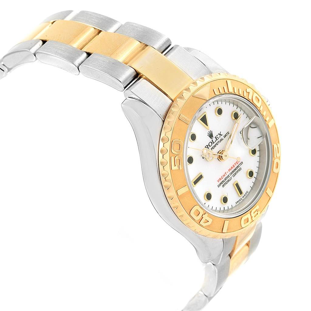This image shows a Rolex Yacht-Master 169623 Women's Steel and Gold (two tone) White Dial 169623 Women's Steel and Gold (two tone) White Dial watch from an angled side view, displaying its gold bezel, dial, and part of the two-tone bracelet.