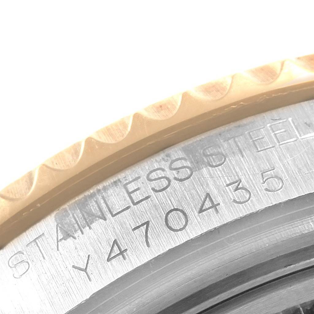 This close-up image shows the case back and part of the bezel of a Rolex Yacht-Master 168623 Men
s Steel and Gold (two tone) White Dial 168623 Men
s Steel and Gold (two tone) White Dial watch, highlighting the serial number engraving.