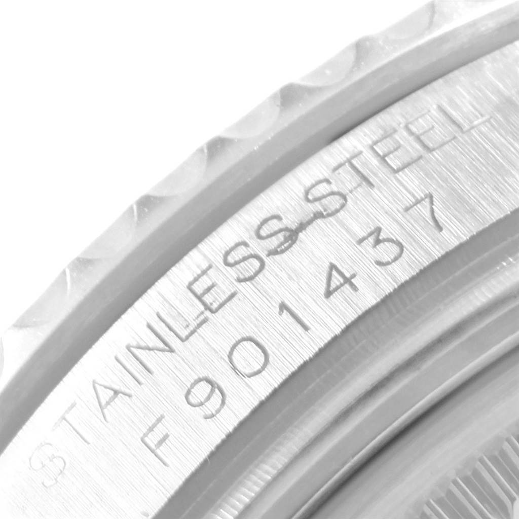 This close-up image of the Rolex Yacht-Master 168622 Men's Stainless Steel Silver Dial 168622 Men's Stainless Steel Silver Dial watch shows the engraved stainless steel case with the serial number.