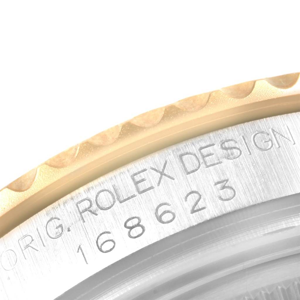 A close-up angle showing the engraved serial number and part of the bezel of the Rolex Yacht-Master 168623 Men's Steel and Gold (two tone) White Dial 168623 Men's Steel and Gold (two tone) White Dial model.