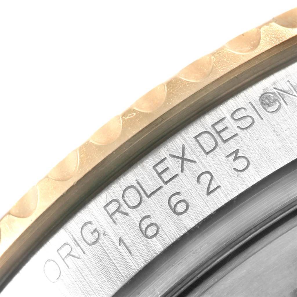 The image shows a close-up of the engraved bezel and the edge of the case back of a Rolex Yacht-Master 16623 Men's Stainless Steel Grey Dial 16623 Men's Stainless Steel Grey Dial watch.