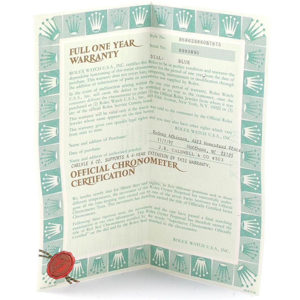 The image shows the warranty certificate for the Rolex Yacht-Master 68628 Yellow Gold Blue Dial 68628 Yellow Gold Blue Dial watch from an angled top view.