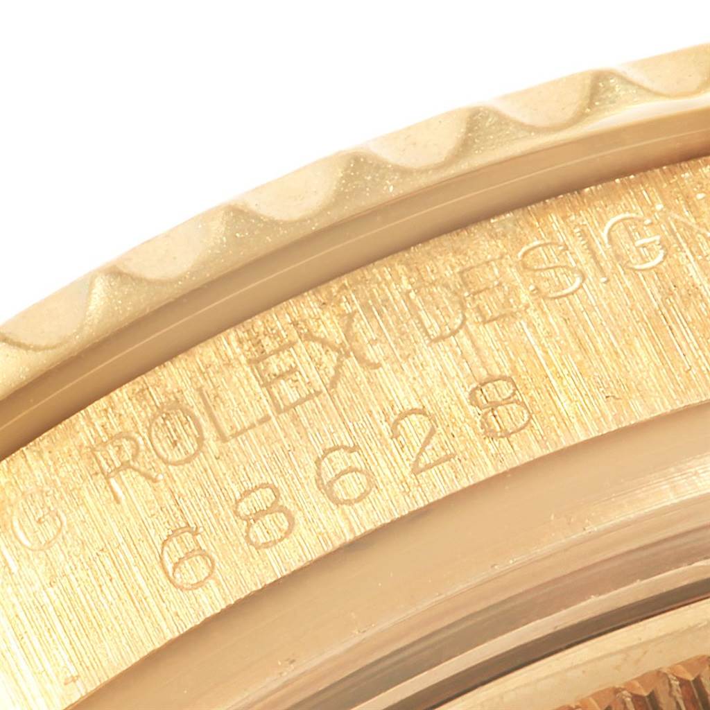 This close-up image shows part of the bezel and engraved model details of a Rolex Yacht-Master 68628 Yellow Gold Blue Dial 68628 Yellow Gold Blue Dial watch.