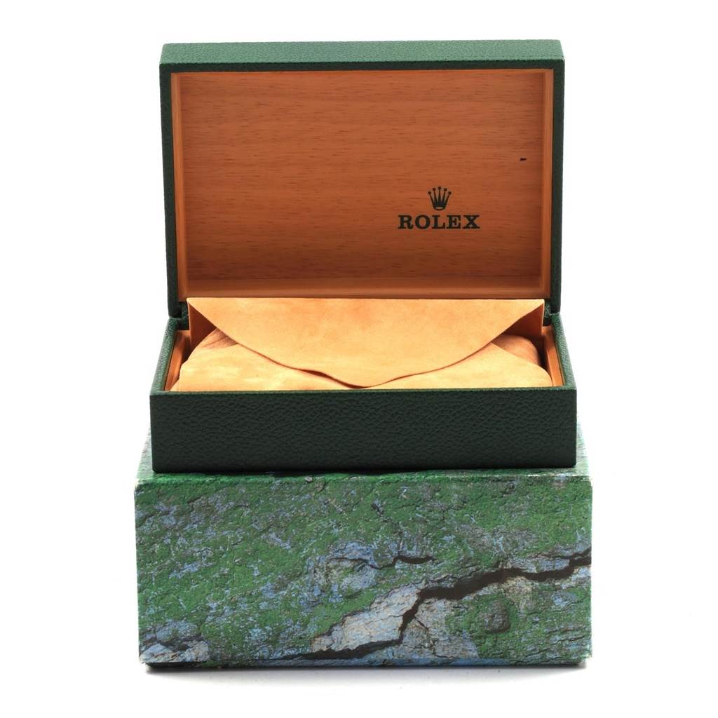 The image shows an open Rolex box containing a Yacht-Master watch, positioned frontally with the watch hidden in an envelope.