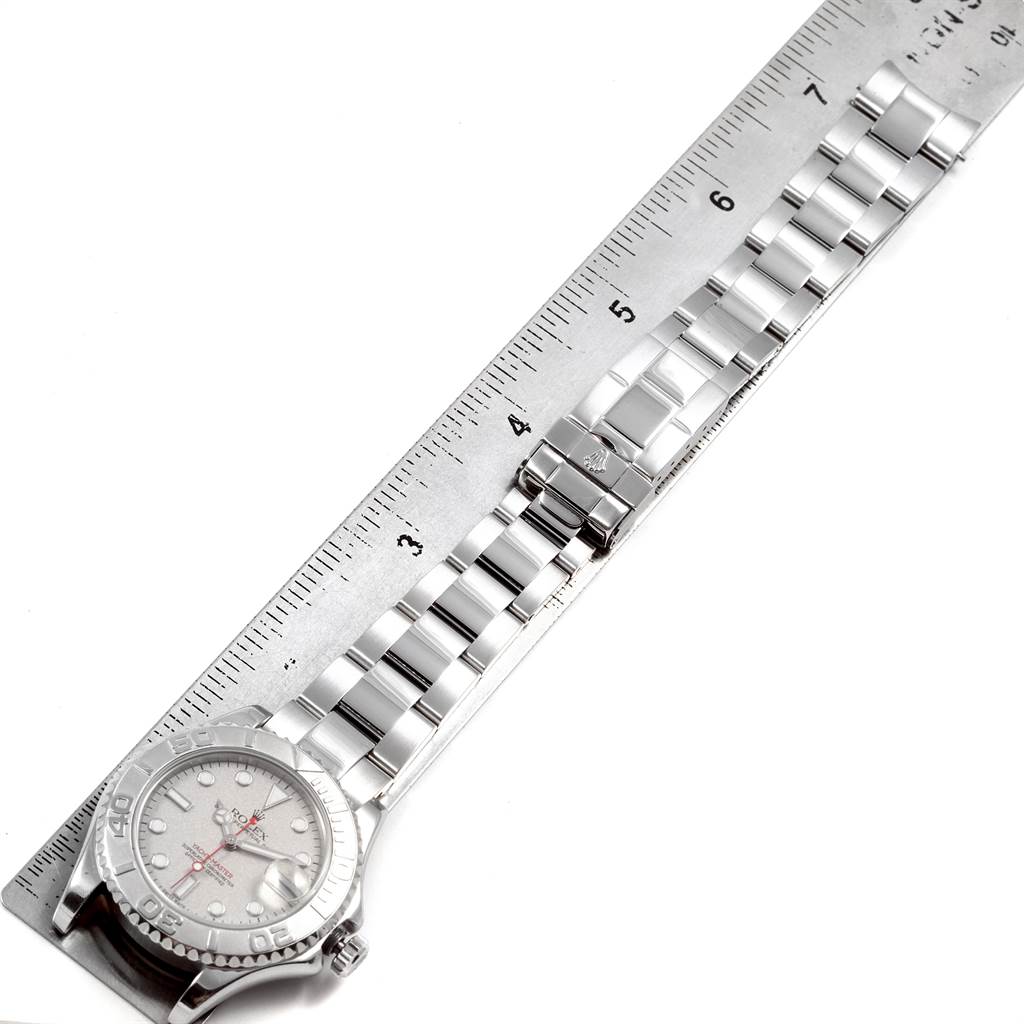 The image shows a top-down view of the Rolex Yacht-Master 168622 Men
s Stainless Steel Silver Dial 168622 Men
s Stainless Steel Silver Dial watch, including the face, bezel, and bracelet placed against a ruler for scale.