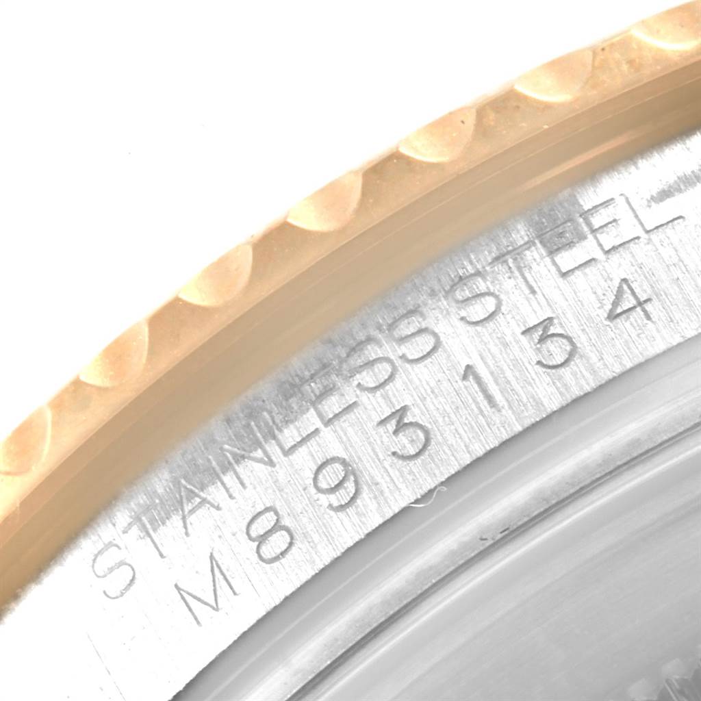 This close-up image of a Rolex Yacht-Master 16623 Men's Stainless Steel Blue Dial 16623 Men's Stainless Steel Blue Dial watch shows the engraved stainless steel case and part of the bezel.