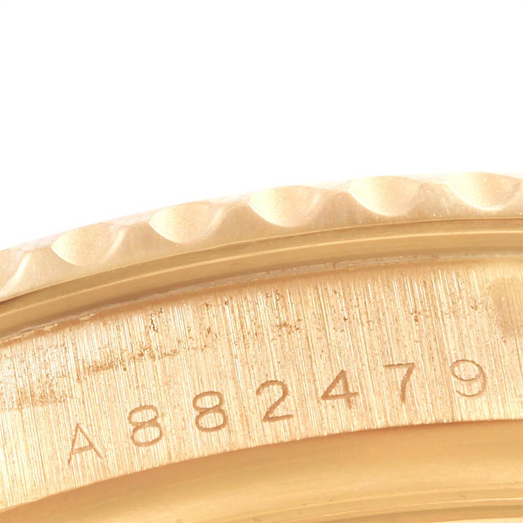 This close-up image shows the serial number engraving on the case back edge of a Rolex Yacht-Master 16628 Men's Yellow Gold White Dial 16628 Men's Yellow Gold White Dial watch.