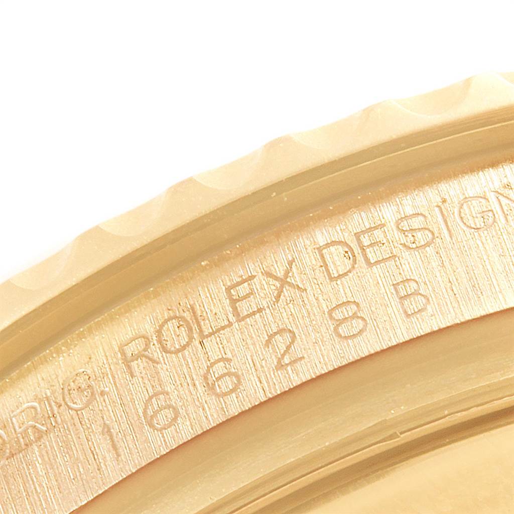 This close-up angle shows the engraved edge and part of the bezel of the Rolex Yacht-Master 16628 Men's Yellow Gold White Dial 16628 Men's Yellow Gold White Dial watch.