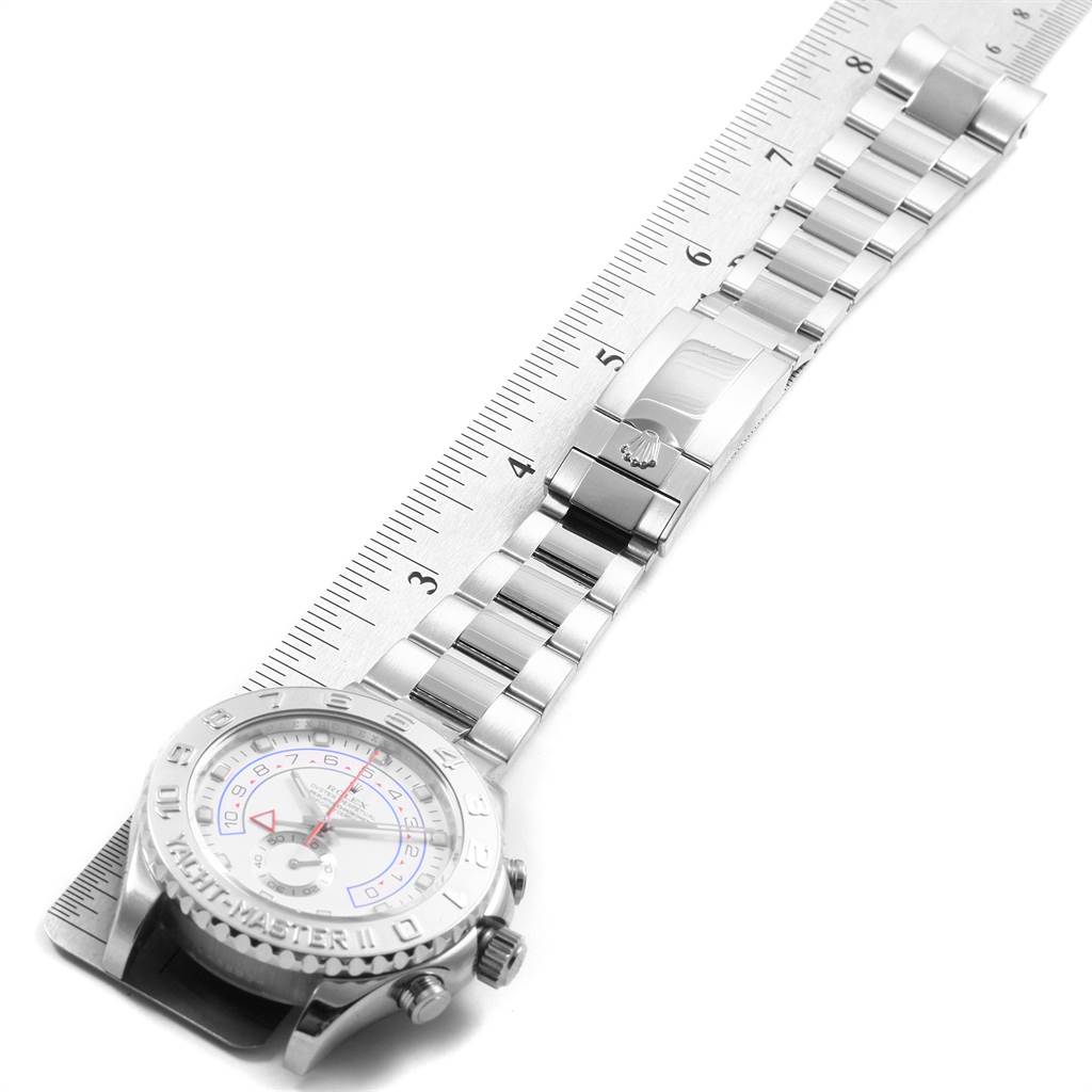 The image shows a side angle of a Rolex Yacht-Master 116689 Men's White Gold White Dial 116689 Men's White Gold White Dial watch lying flat, with focus on the face, bezel, and bracelet measured by a metal ruler.