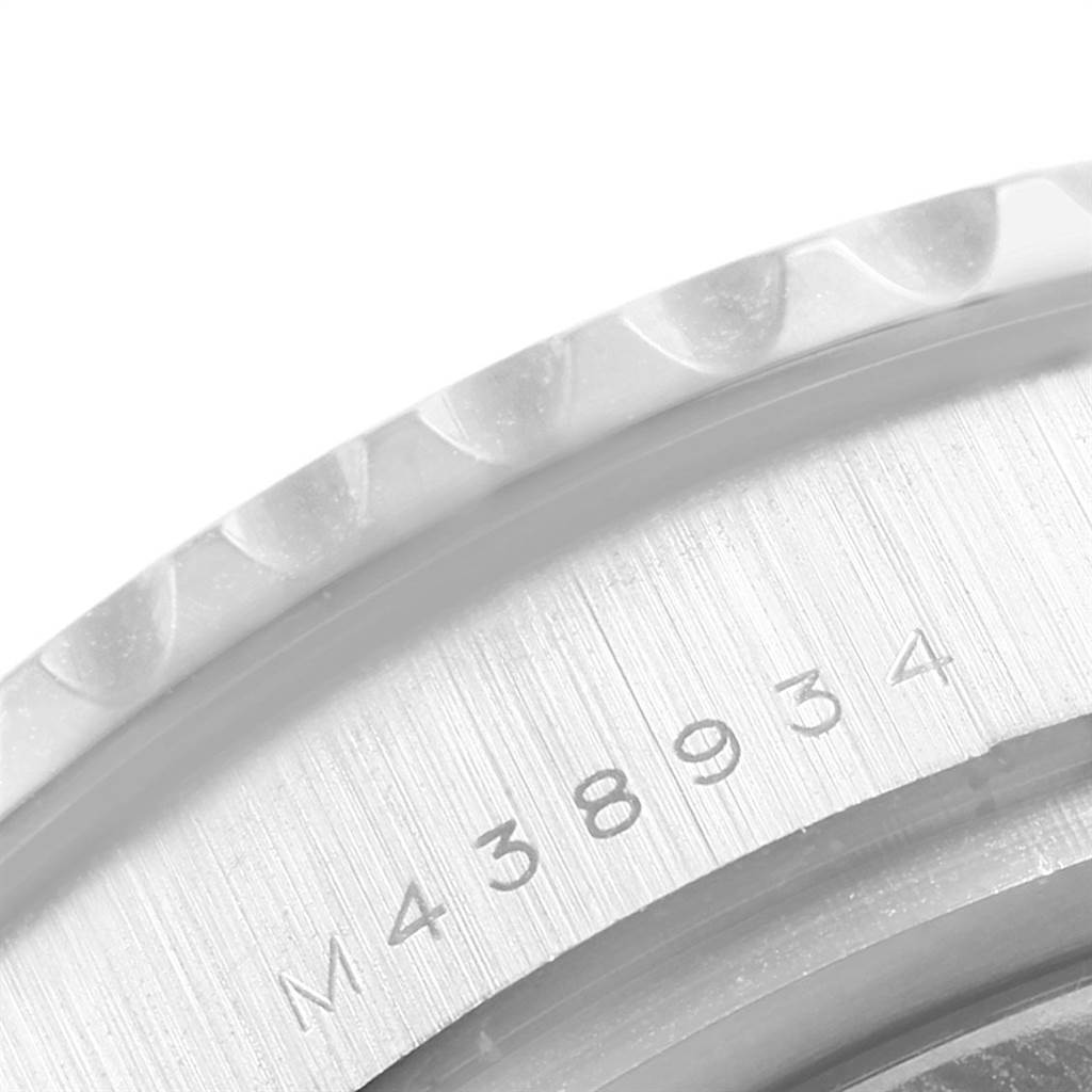 The image shows a close-up of the engraved serial number on the case back and bezel edge of a Rolex Yacht-Master 116689 Men's White Gold White Dial 116689 Men's White Gold White Dial watch.