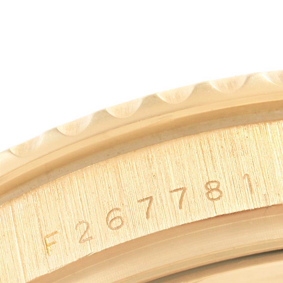 This image shows a close-up of the Rolex Yacht-Master 16628 Men's Yellow Gold White Dial 16628 Men's Yellow Gold White Dial watch bezel and its engraved serial number.