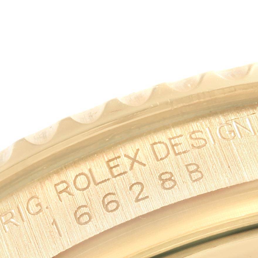 This is a close-up image of the bezel and edge of a Rolex Yacht-Master 16628 Men's Yellow Gold White Dial 16628 Men's Yellow Gold White Dial watch, showing the engraved text and model number.