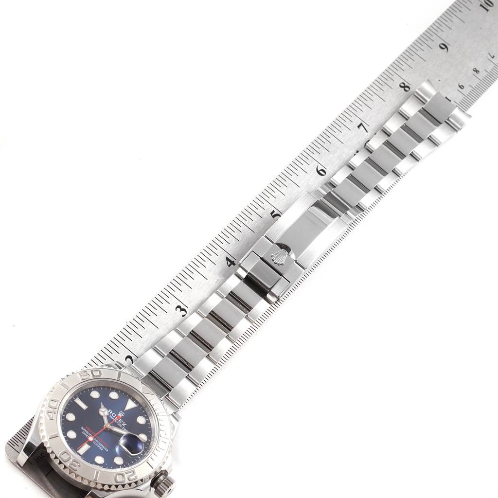 The image shows a top view of the Rolex Yacht-Master 116622 Men's Stainless Steel Blue Dial 116622 Men's Stainless Steel Blue Dial watch with its bracelet placed next to a ruler for measurement.