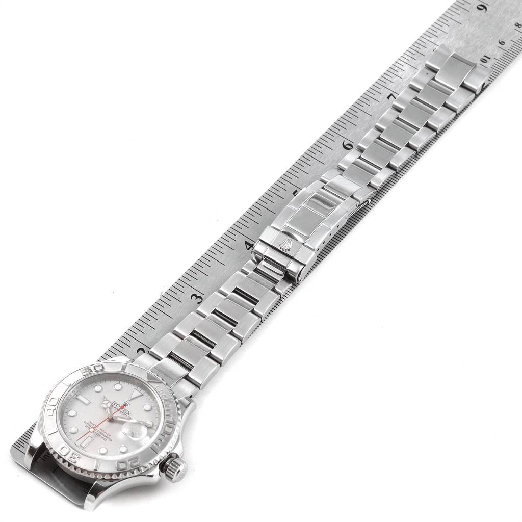 The Rolex Yacht-Master 16622 Men's Stainless Steel Silver Dial 16622 Men's Stainless Steel Silver Dial watch is shown from a top-down angle, featuring its dial and metal bracelet against a measuring ruler.